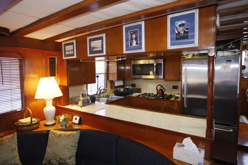 Slide: The Image of Interior of 1982 DeFever 52 Offshore Cruiser with cozy kitchen and seating area. - 21