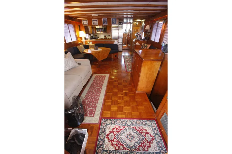 Slide: The Image of Interior of 1982 DeFever 52 Offshore Cruiser with wooden decor and cozy seating area. - 24