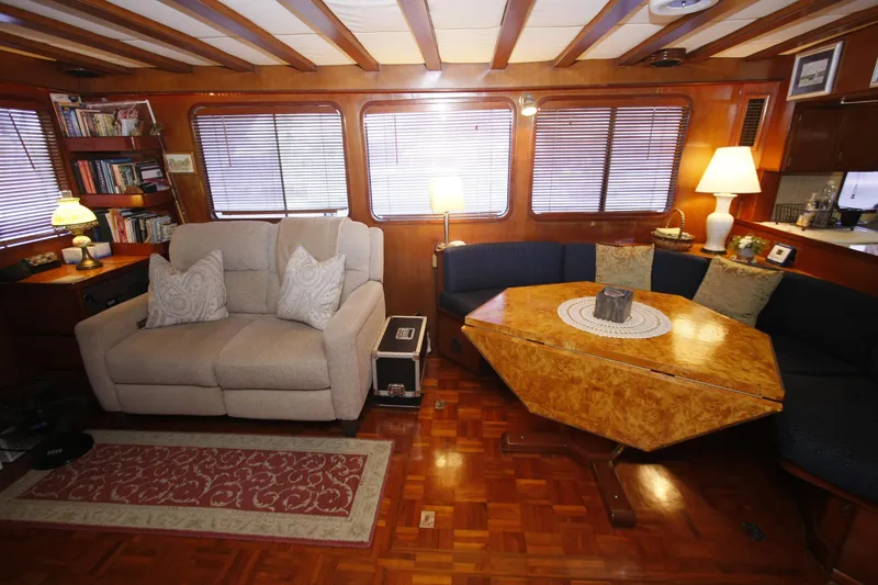 Slide: The Image of Cozy interior of 1982 DeFever 52 Offshore Cruiser with sofa, table, and bookshelves. - 26