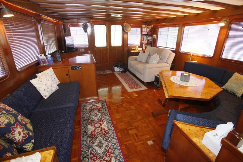 Slide: The Image of Interior of 1982 DeFever 52 Offshore Cruiser with cozy seating and wooden decor. - 27