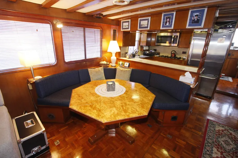 Slide: The Image of Interior of 1982 DeFever 52 Offshore Cruiser with cozy dining area and wooden decor. - 28
