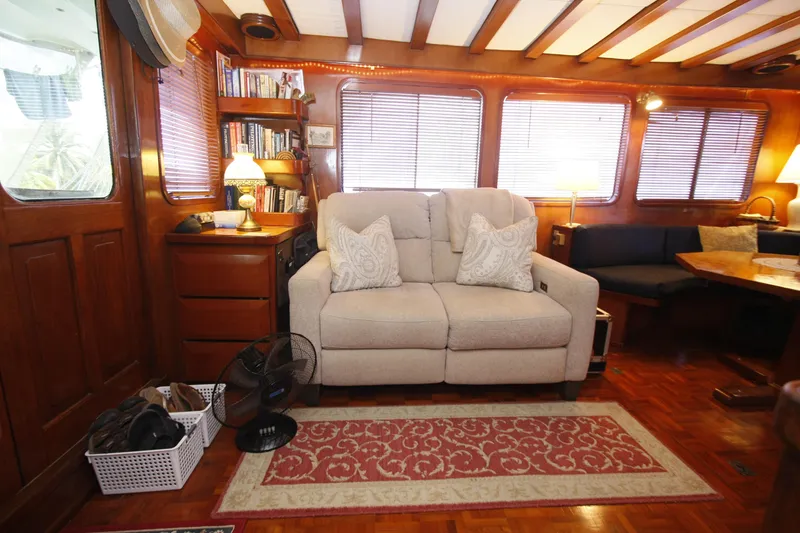 Slide: The Image of Interior of 1982 DeFever 52 Offshore Cruiser with cozy seating and wooden decor. - 31