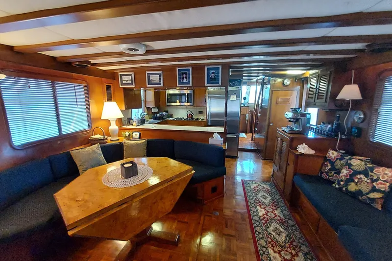 Slide: The Image of Interior of 1982 DeFever 52 Offshore Cruiser with cozy seating and wooden decor. - 33