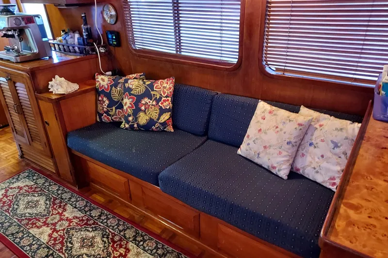 Slide: The Image of Interior of 1982 DeFever 52 Offshore Cruiser with cozy seating and floral cushions. - 35