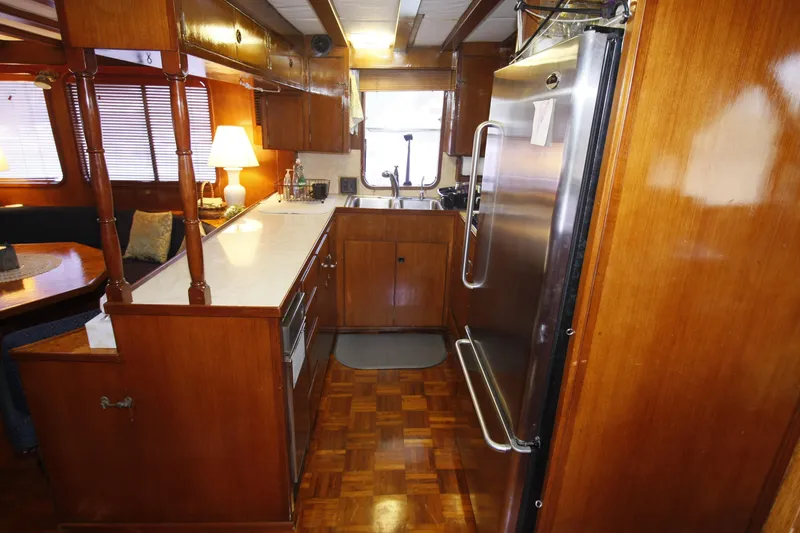 Slide: The Image of 1982 DeFever 52 Offshore Cruiser kitchen with wood cabinetry and stainless steel appliances. - 38