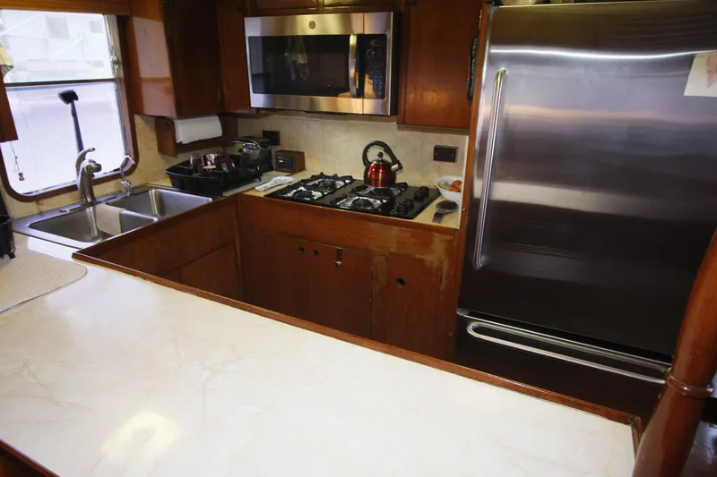 Slide: The Image of Galley kitchen in 1982 DeFever 52 Offshore Cruiser with stainless steel appliances. - 41