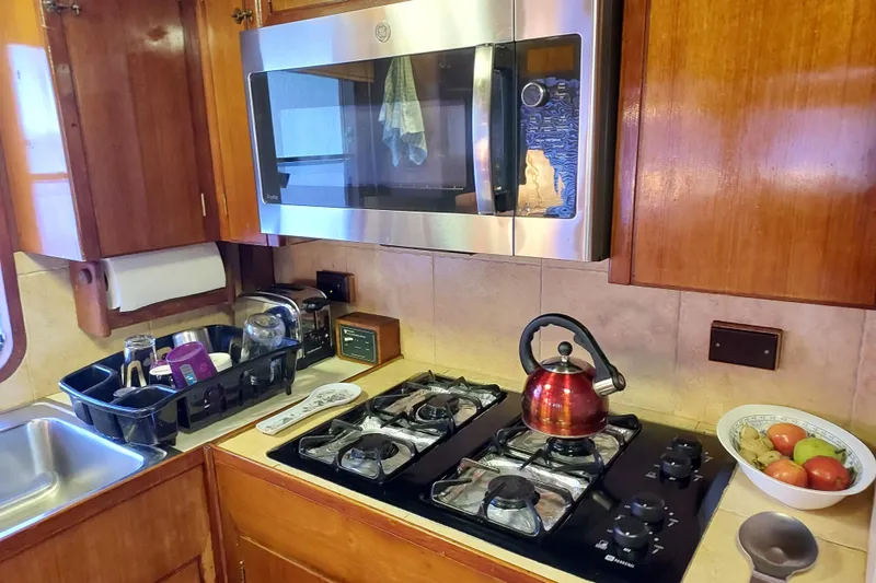 Slide: The Image of Galley kitchen in 1982 DeFever 52 Offshore Cruiser with stove, microwave, and sink. - 43