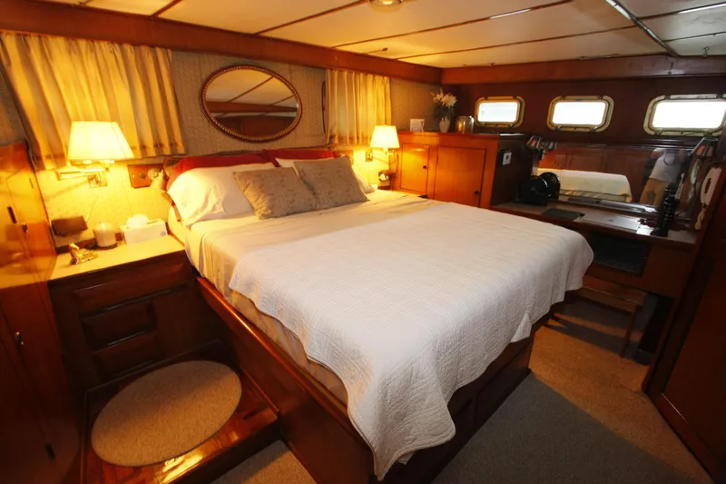 Slide: The Image of Luxurious cabin interior of 1982 DeFever 52 Offshore Cruiser with cozy bed and warm lighting. - 48