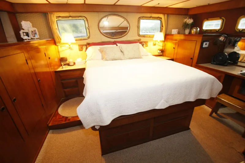 Slide: The Image of Luxurious 1982 DeFever 52 Offshore Cruiser bedroom with wood paneling and cozy decor. - 49