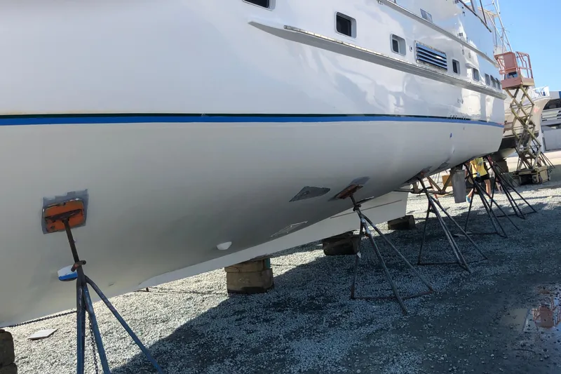 Slide: The Image of 1982 DeFever 52 Offshore Cruiser on stands for maintenance, side view. - 5