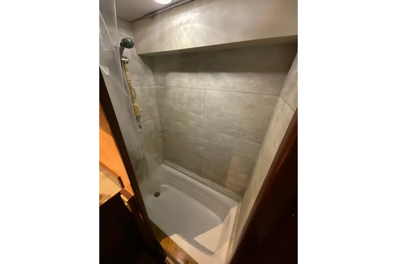 Slide: The Image of Shower area in 1982 DeFever 52 Offshore Cruiser with tiled walls and modern fixtures. - 53