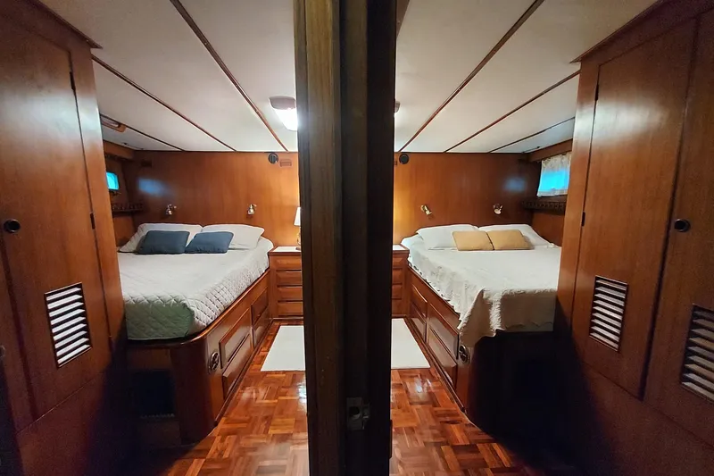 Slide: The Image of Luxurious 1982 DeFever 52 Offshore Cruiser cabin with twin beds and elegant wood finish. - 56