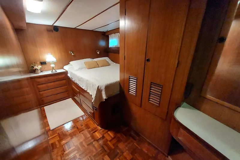 Slide: The Image of Cozy bedroom in 1982 DeFever 52 Offshore Cruiser with wood paneling and double bed. - 57