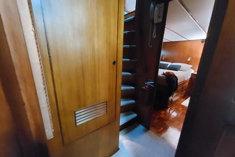 Slide: The Image of Interior of 1982 DeFever 52 Offshore Cruiser with wooden stairs and cozy bedroom. - 63