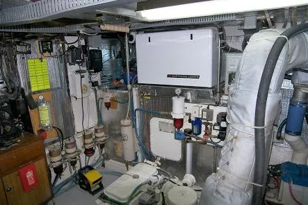 Slide: The Image of Engine room of 1982 DeFever 52 Offshore Cruiser with various mechanical components and equipment. - 64
