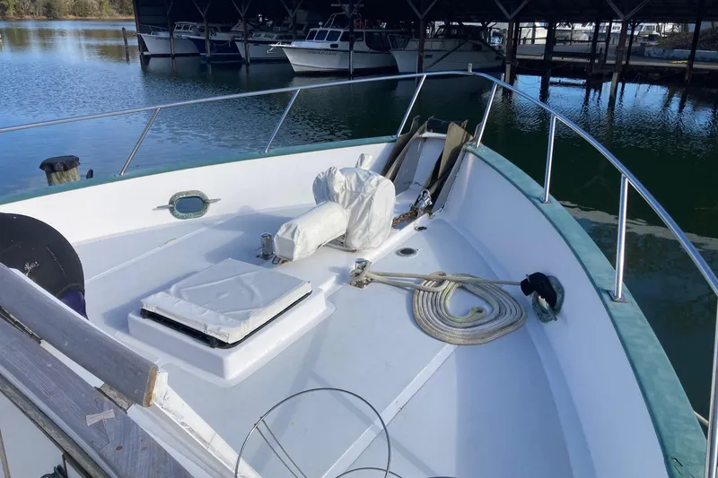 Slide: The Image of 1982 DeFever 52 Offshore Cruiser bow with ropes and covered equipment. - 67