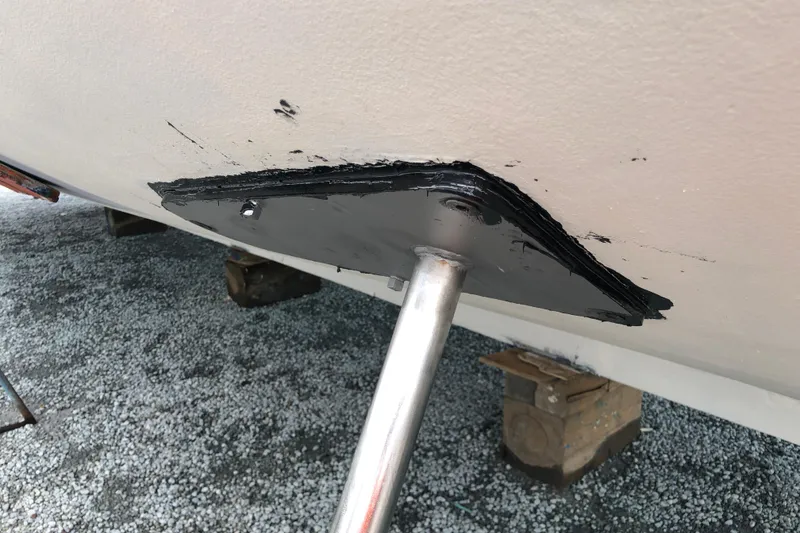 Slide: The Image of 1982 DeFever 52 Offshore Cruiser propeller shaft detail, showing hull attachment and protective coating. - 7