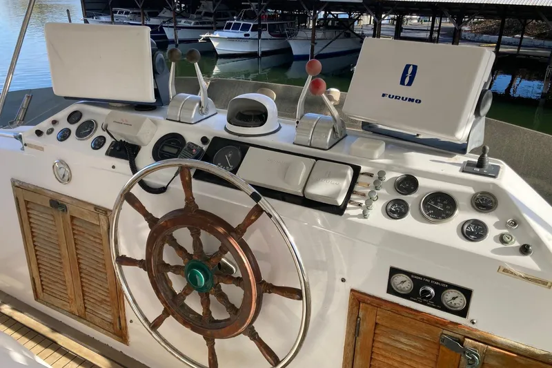 Slide: The Image of Helm of 1982 DeFever 52 Offshore Cruiser with wooden wheel and navigation instruments. - 71