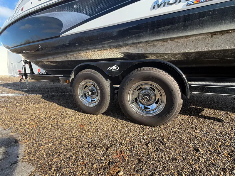 Slide: The Image of 2023 Monterey M6 boat on trailer, close-up of wheels. - 11