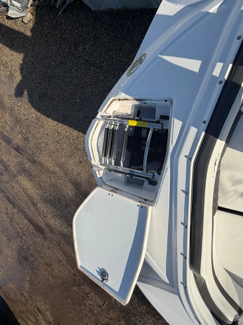 Slide: The Image of 2023 Monterey M6 boat with open rear hatch and ladder. - 44