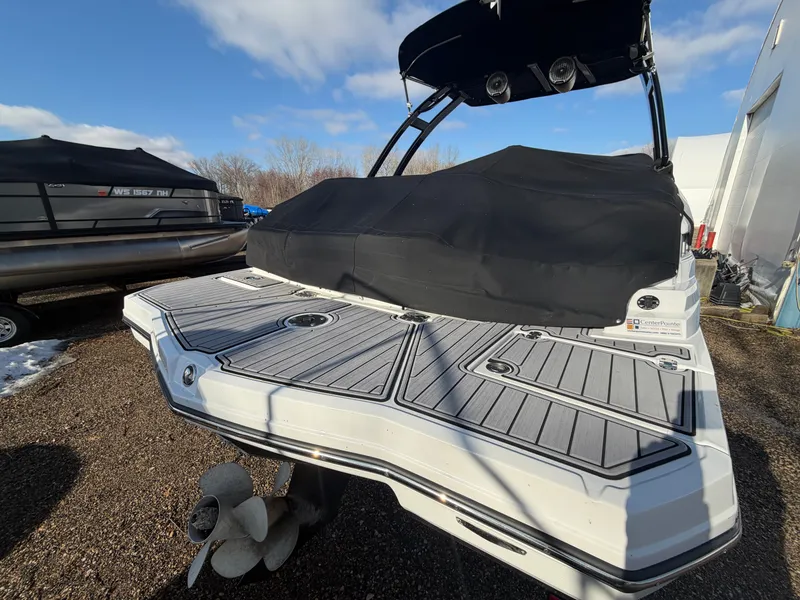 Slide: The Image of 2023 Monterey M6 boat with cover, parked outdoors. - 6