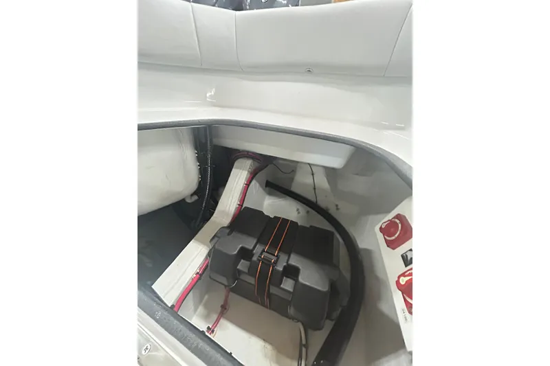 Slide: The Image of 2024 Contender 24 Sport boat interior showing battery compartment and wiring. - 15