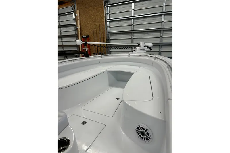 Slide: The Image of 2024 Contender 24 Sport boat interior with seating and storage in a garage setting. - 22