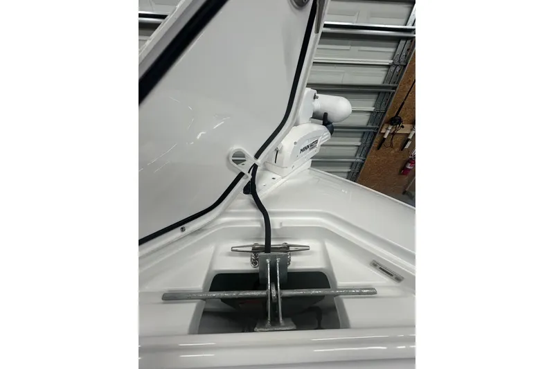 Slide: The Image of 2024 Contender 24 Sport boat anchor compartment with Minn Kota trolling motor. - 24