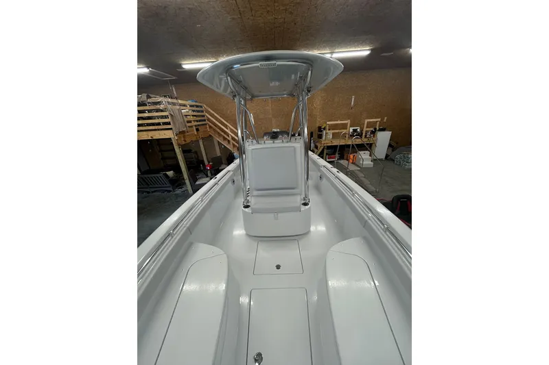 Slide: The Image of 2024 Contender 24 Sport boat interior with T-top in a garage setting. - 29