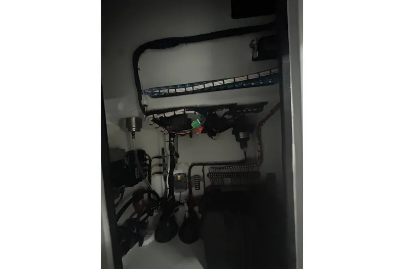 Slide: The Image of Electrical wiring and components inside a 2024 Contender 24 Sport boat. - 30