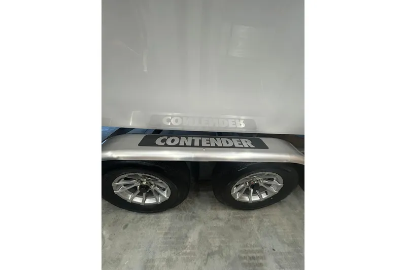 Slide: The Image of 2024 Contender 24 Sport boat trailer with dual wheels and branded fender. - 33