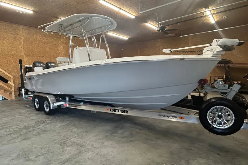 Slide: The Image of 2024 Contender 24 Sport boat on trailer in a garage setting. - 35
