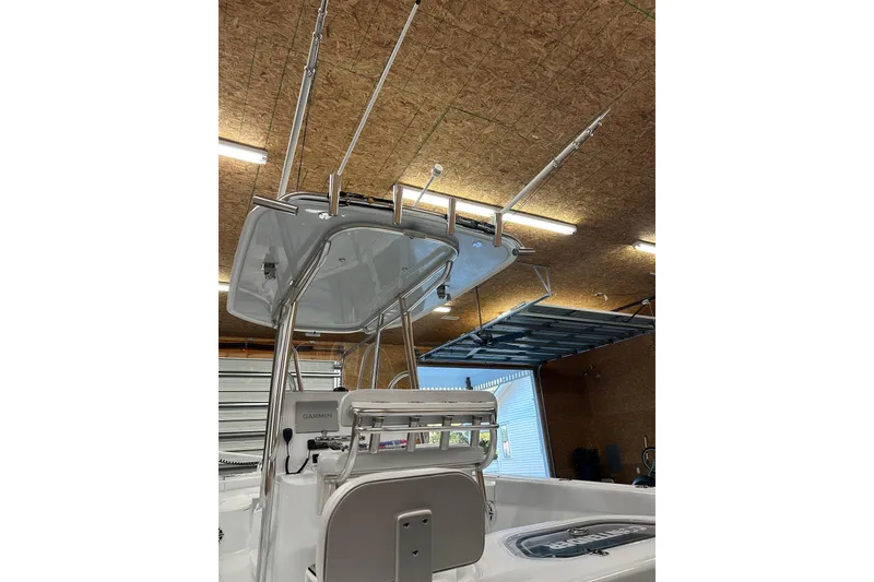 Slide: The Image of 2024 Contender 24 Sport boat interior with fishing rod holders and Garmin equipment. - 37