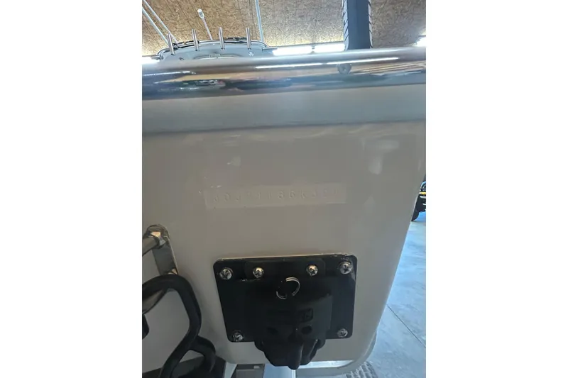 Slide: The Image of 2024 Contender 24 Sport boat transom detail in a showroom setting. - 7