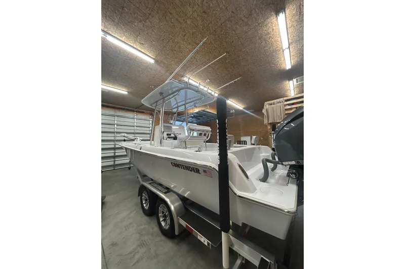 Slide: The Image of 2024 Contender 24 Sport boat in a garage, showcasing sleek design and modern features. - 8