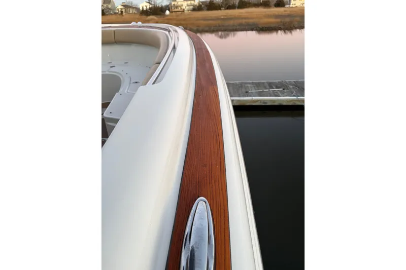 Slide: The Image of 2019 Chris-Craft Catalina 26 boat with sleek wooden trim detail. - 10