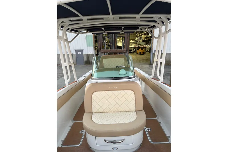 Slide: The Image of 2019 Chris-Craft Catalina 26 boat interior with tan seating and canopy. - 11