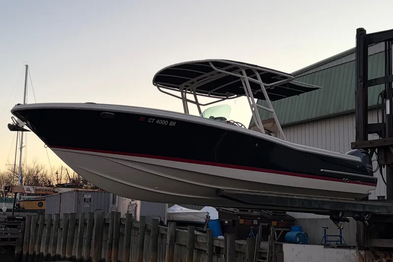 Slide: The Image of 2019 Chris-Craft Catalina 26 boat on lift at marina during sunset. - 2