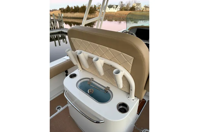 Slide: The Image of 2019 Chris-Craft Catalina 26 boat interior with rod holders and cushioned seating. - 8