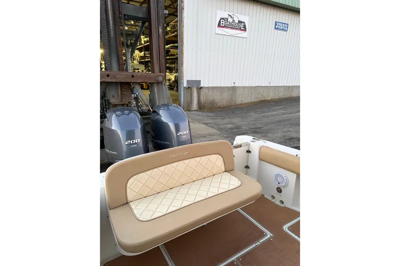 Slide: The Image of 2019 Chris-Craft Catalina 26 boat with Yamaha 200 engines, docked near a boathouse. - 9