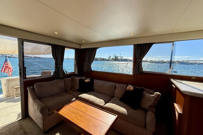 Slide: The Image of Interior of 1985 Chris-Craft 382 Commander yacht with ocean view and cozy seating. - 10