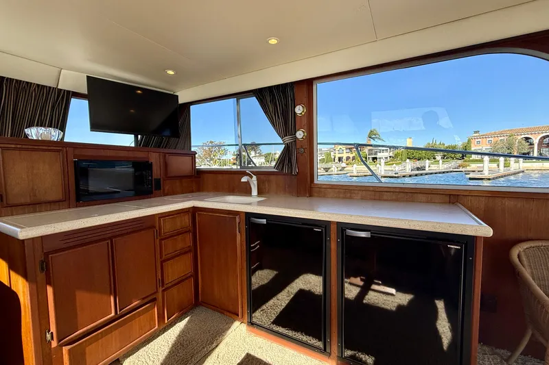 Slide: The Image of Interior of 1985 Chris-Craft 382 Commander yacht with kitchen and waterfront view. - 13