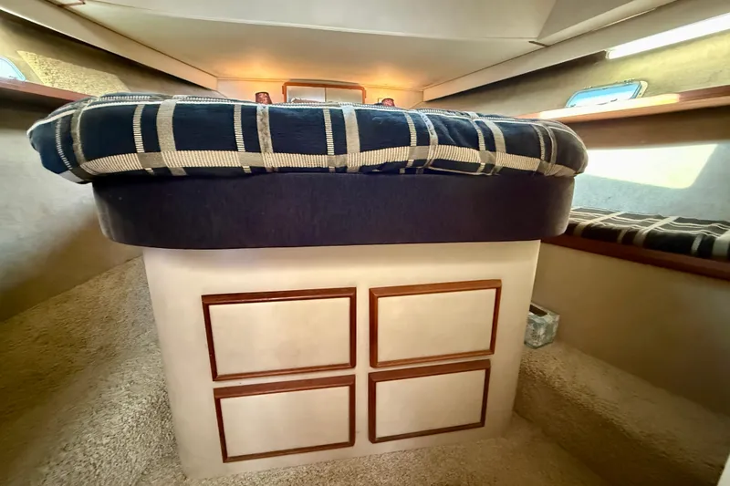 Slide: The Image of 1985 Chris-Craft 382 Commander cabin interior with plaid bedding and storage drawers. - 24