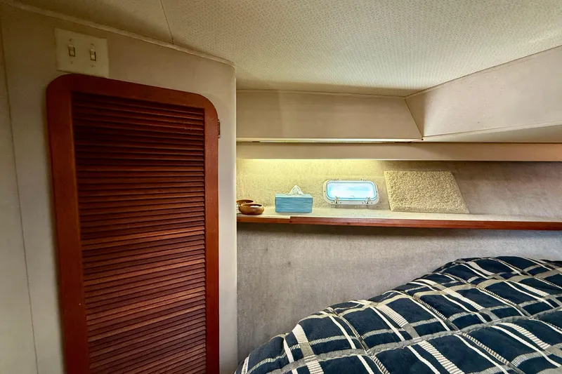 Slide: The Image of 1985 Chris-Craft 382 Commander cabin interior with wood paneling and nautical decor. - 25