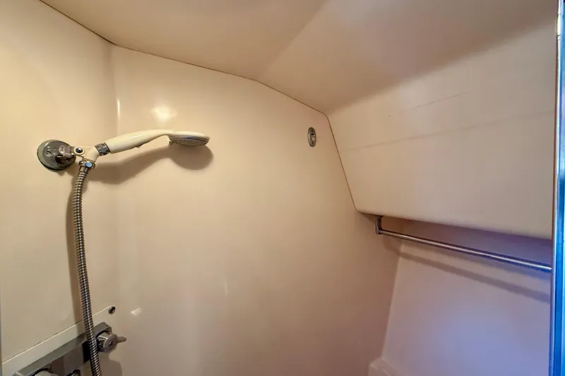 Slide: The Image of Shower area in 1985 Chris-Craft 382 Commander boat, featuring handheld showerhead and rail. - 28