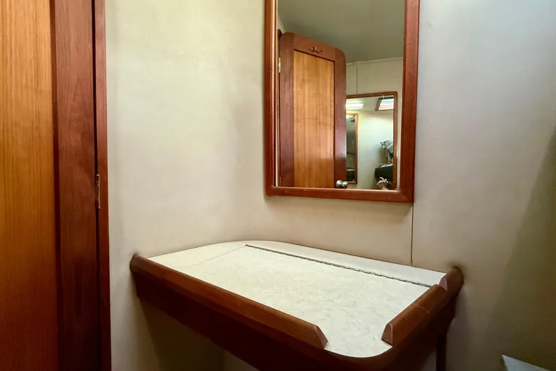 Slide: The Image of 1985 Chris-Craft 382 Commander interior with wooden vanity and mirror. - 32