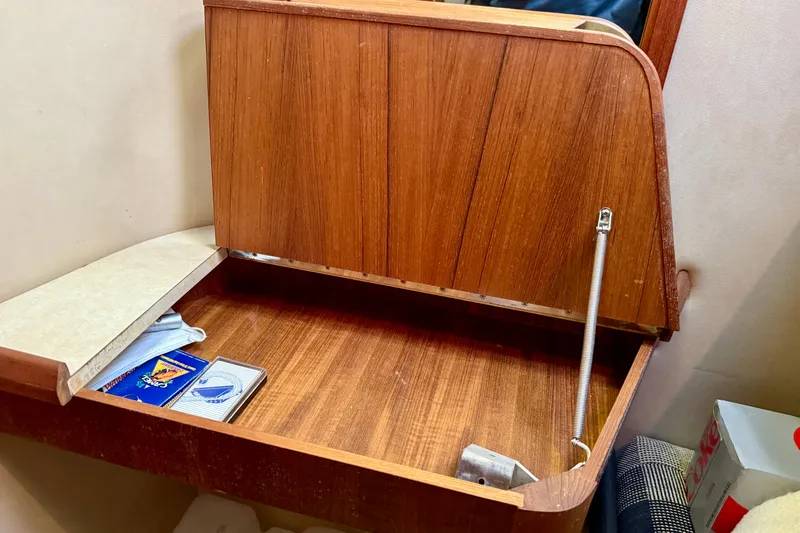 Slide: The Image of 1985 Chris-Craft 382 Commander interior with wooden storage compartment and playing cards. - 33