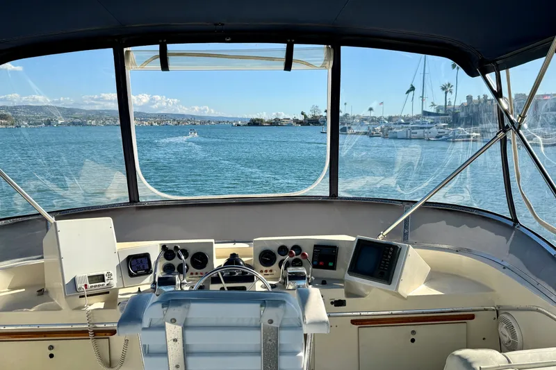 Slide: The Image of Helm view of 1985 Chris-Craft 382 Commander on a sunny day, overlooking marina. - 40