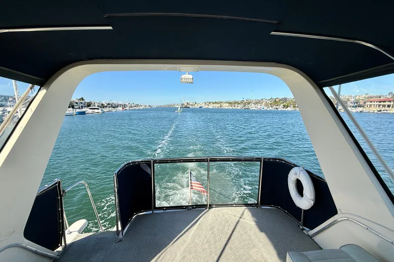 Slide: The Image of View from 1985 Chris-Craft 382 Commander yacht, overlooking serene waters and distant shoreline. - 42
