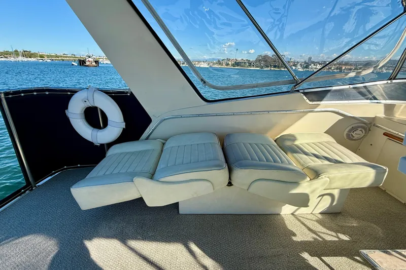 Slide: The Image of 1985 Chris-Craft 382 Commander interior with plush seating and scenic water view. - 47